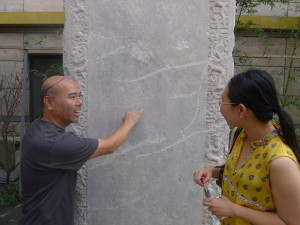 Museum Curator Mr Yuan Qiulai shows the names of the patrons who helped fund the rebuilding over the past 5 centuries
